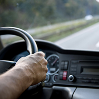 man holding steering wheel